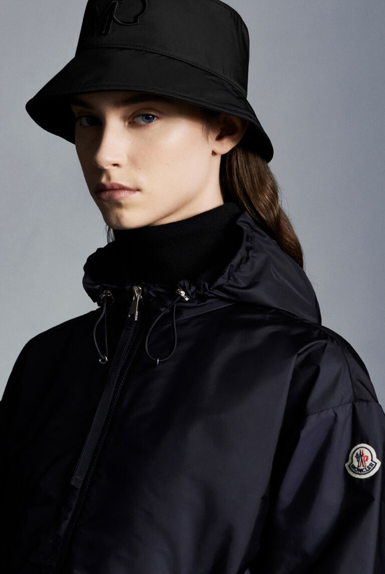 A woman wearing a Moncler jacket and a black hat